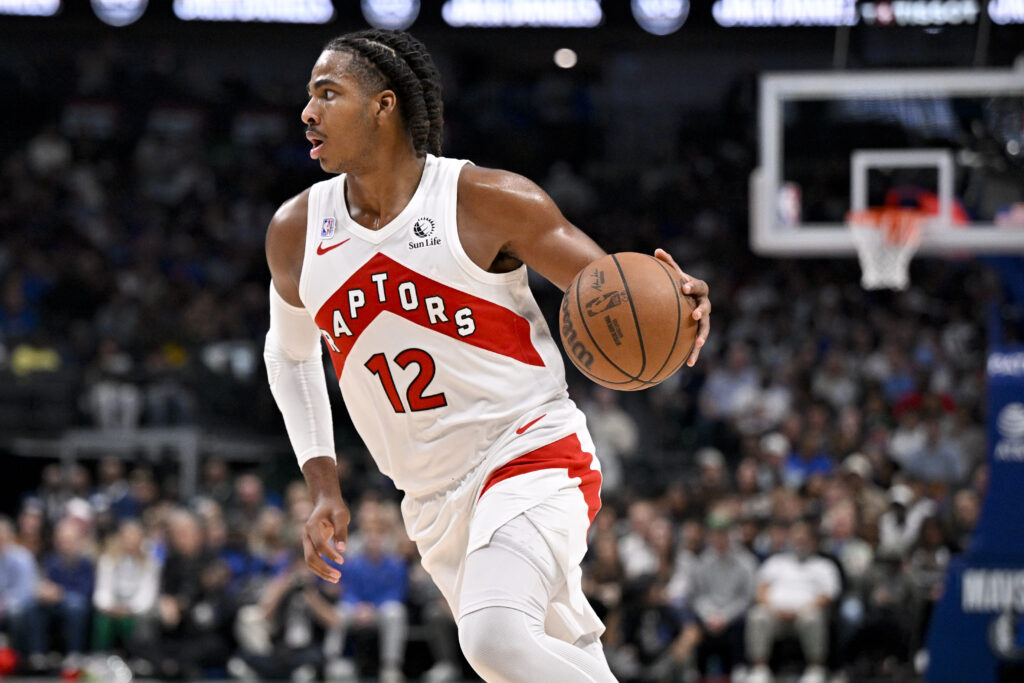 Oct 26, 2025; Dallas, Texas, USA; Toronto Raptors forward Collin Murray-Boyles (12) brings the ball up court against the Dallas Mavericks during the second quarter at the American Airlines Center. Mandatory Credit: Jerome Miron-Imagn Images