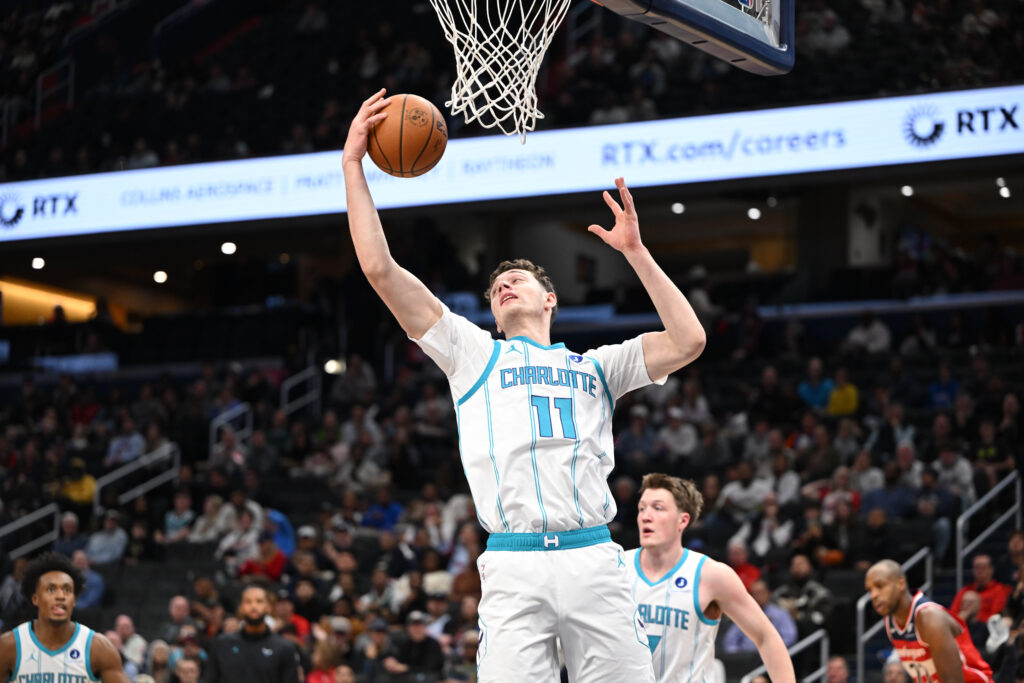 Oct 26, 2025; Washington, District of Columbia, USA; Charlotte Hornets center Ryan Kalkbrenner (11) grabs a rebound against the Washington Wizards during the first quarter at Capital One Arena. Mandatory Credit: Rafael Suanes-Imagn Images