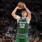 Oct 26, 2025; Dallas, Texas, USA; Dallas Mavericks forward Cooper Flagg (32) makes a three point shot against the Toronto Raptors during the second half at the American Airlines Center. Mandatory Credit: Jerome Miron-Imagn Images