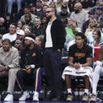 Oct 27, 2025; Salt Lake City, Utah, USA; Phoenix Suns forward Dillon Brooks, center, watches play from the bench wearing street clothes during the second half of a game against the Utah Jazz at Delta Center. Mandatory Credit: Rob Gray-Imagn Images