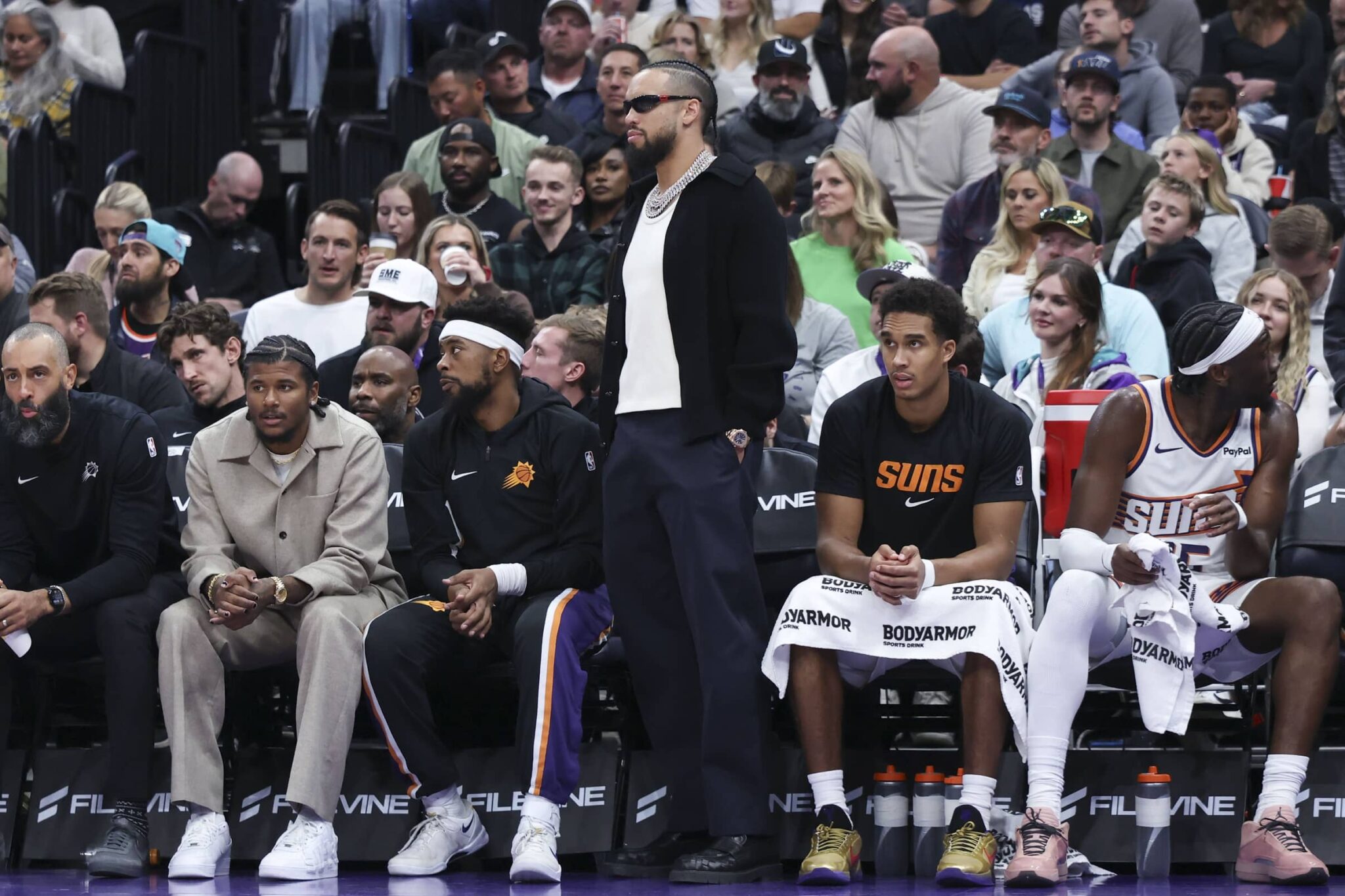Oct 27, 2025; Salt Lake City, Utah, USA; Phoenix Suns forward Dillon Brooks, center, watches play from the bench wearing street clothes during the second half of a game against the Utah Jazz at Delta Center. Mandatory Credit: Rob Gray-Imagn Images