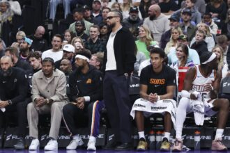 Oct 27, 2025; Salt Lake City, Utah, USA; Phoenix Suns forward Dillon Brooks, center, watches play from the bench wearing street clothes during the second half of a game against the Utah Jazz at Delta Center. Mandatory Credit: Rob Gray-Imagn Images