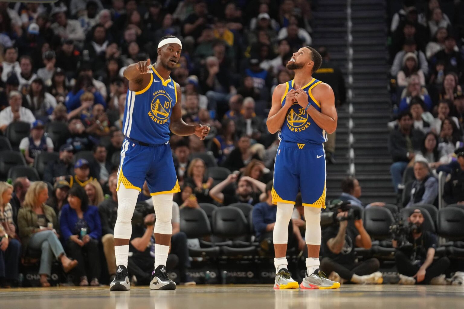 Oct 27, 2025; San Francisco, California, USA; Golden State Warriors forward Jimmy Butler III (10) talks with guard Stephen Curry (30) during a break in the action against the Memphis Grizzlies in the third quarter at the Chase Center. Mandatory Credit: Cary Edmondson-Imagn Images