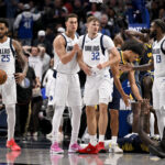 Oct 29, 2025; Dallas, Texas, USA; Dallas Mavericks forward P.J. Washington (25) and forward Dwight Powell (7) and forward Cooper Flagg (32) and forward Naji Marshall (13) react to the win over the Indiana Pacers at the American Airlines Center. Mandatory Credit: Jerome Miron-Imagn Images