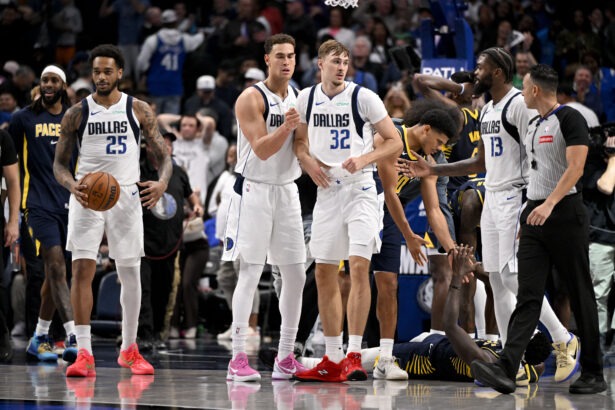 Oct 29, 2025; Dallas, Texas, USA; Dallas Mavericks forward P.J. Washington (25) and forward Dwight Powell (7) and forward Cooper Flagg (32) and forward Naji Marshall (13) react to the win over the Indiana Pacers at the American Airlines Center. Mandatory Credit: Jerome Miron-Imagn Images