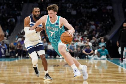 Nov 1, 2025; Charlotte, North Carolina, USA; Charlotte Hornets guard Kon Knueppel (7) handles the ball against Minnesota Timberwolves guard Mike Conley (10) during the second quarter at Spectrum Center. Mandatory Credit: Jim Dedmon-Imagn Images