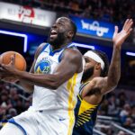 Nov 1, 2025; Indianapolis, Indiana, USA; Golden State Warriors forward Draymond Green (23) shoots the ball while Indiana Pacers forward Isaiah Jackson (22) defends in the first half at Gainbridge Fieldhouse. Mandatory Credit: Trevor Ruszkowski-Imagn Images