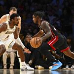Nov 2, 2025; Los Angeles, California, USA; Los Angeles Lakers guard Bronny James (9) defends against Miami Heat guard Davion Mitchell (45) during the second half at Crypto.com Arena. Mandatory Credit: Jonathan Hui-Imagn Images
