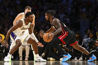 Nov 2, 2025; Los Angeles, California, USA; Los Angeles Lakers guard Bronny James (9) defends against Miami Heat guard Davion Mitchell (45) during the second half at Crypto.com Arena. Mandatory Credit: Jonathan Hui-Imagn Images