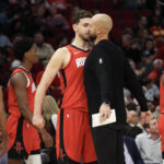 Nov 3, 2025; Houston, Texas, USA; Houston Rockets center Alperen Sengun (28) chest bumps assistant coach Vince Sullivan during a Dallas Mavericks timeout in the second quarter at Toyota Center. Mandatory Credit: Thomas Shea-Imagn Images