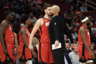 Nov 3, 2025; Houston, Texas, USA; Houston Rockets center Alperen Sengun (28) chest bumps assistant coach Vince Sullivan during a Dallas Mavericks timeout in the second quarter at Toyota Center. Mandatory Credit: Thomas Shea-Imagn Images