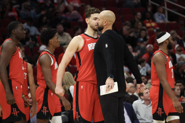 Nov 3, 2025; Houston, Texas, USA; Houston Rockets center Alperen Sengun (28) chest bumps assistant coach Vince Sullivan during a Dallas Mavericks timeout in the second quarter at Toyota Center. Mandatory Credit: Thomas Shea-Imagn Images