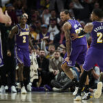 Nov 3, 2025; Portland, Oregon, USA; Los Angeles Lakers guard Nick Smith Jr. (20) reacts with teammate forward Rui Hachimura (28) after scoring a basket during the second half against the Portland Trail Blazers at Moda Center. Mandatory Credit: Troy Wayrynen-Imagn Images