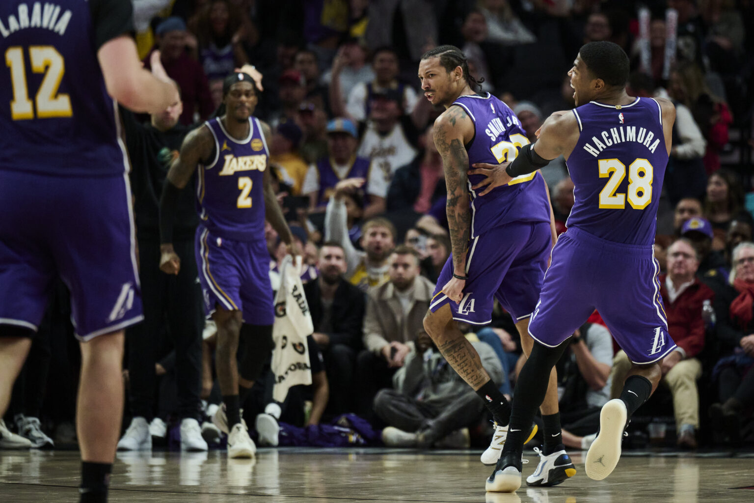 Nov 3, 2025; Portland, Oregon, USA; Los Angeles Lakers guard Nick Smith Jr. (20) reacts with teammate forward Rui Hachimura (28) after scoring a basket during the second half against the Portland Trail Blazers at Moda Center. Mandatory Credit: Troy Wayrynen-Imagn Images