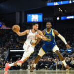 Nov 4, 2025; San Francisco, California, USA; Phoenix Suns guard Devin Booker (1) drives to the basket against Golden State Warriors forward Jonathan Kuminga (1) in the second quarter at Chase Center. Mandatory Credit: Eakin Howard-Imagn Images