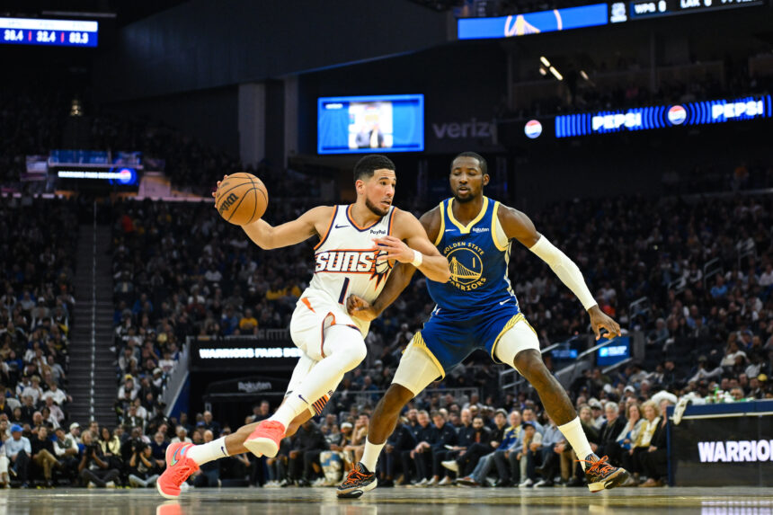Nov 4, 2025; San Francisco, California, USA; Phoenix Suns guard Devin Booker (1) drives to the basket against Golden State Warriors forward Jonathan Kuminga (1) in the second quarter at Chase Center. Mandatory Credit: Eakin Howard-Imagn Images