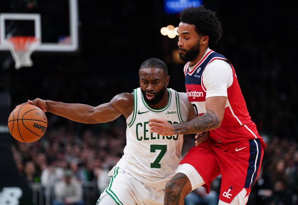 Nov 5, 2025; Boston, Massachusetts, USA; Boston Celtics guard/forward Jaylen Brown (7) drives the ball against Washington Wizards guard/forward Justin Champagnie (9) in the second half at TD Garden. Mandatory Credit: David Butler II-Imagn Images