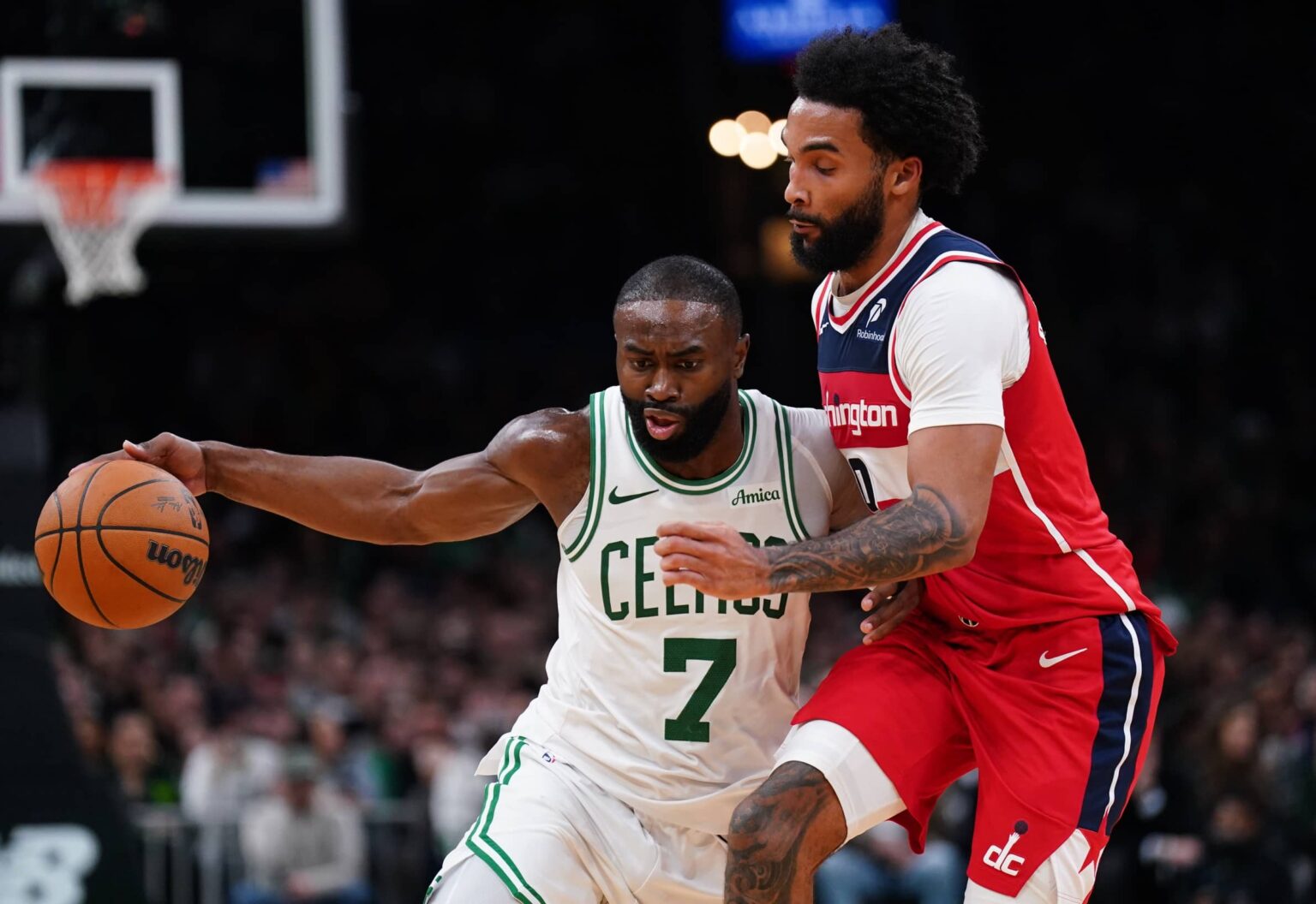 Nov 5, 2025; Boston, Massachusetts, USA; Boston Celtics guard/forward Jaylen Brown (7) drives the ball against Washington Wizards guard/forward Justin Champagnie (9) in the second half at TD Garden. Mandatory Credit: David Butler II-Imagn Images