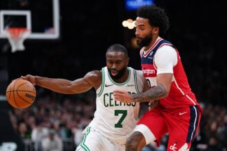 Nov 5, 2025; Boston, Massachusetts, USA; Boston Celtics guard/forward Jaylen Brown (7) drives the ball against Washington Wizards guard/forward Justin Champagnie (9) in the second half at TD Garden. Mandatory Credit: David Butler II-Imagn Images