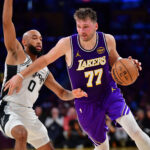 Nov 5, 2025; Los Angeles, California, USA; Los Angeles Lakers guard Luka Doncic (77) moves the ball against San Antonio Spurs guard Jordan McLaughlin (0) during the first half at Crypto.com Arena. Mandatory Credit: Gary A. Vasquez-Imagn Images
