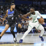 Nov 7, 2025; Orlando, Florida, USA; Boston Celtics guard Jaylen Brown (7) is guardedly Orlando Magic guard Jalen Suggs (4) in the second quarter at Kia Center. Mandatory Credit: Nathan Ray Seebeck-Imagn Images