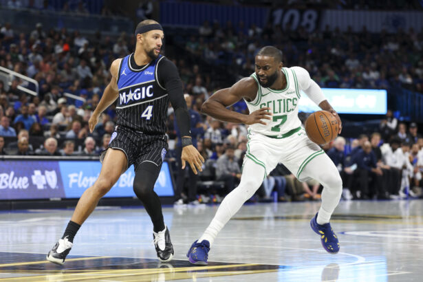 Nov 7, 2025; Orlando, Florida, USA; Boston Celtics guard Jaylen Brown (7) is guardedly Orlando Magic guard Jalen Suggs (4) in the second quarter at Kia Center. Mandatory Credit: Nathan Ray Seebeck-Imagn Images
