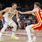 Nov 8, 2025; Atlanta, Georgia, USA; Los Angeles Lakers guard Luka Doncic (77) dribbles guarded by Atlanta Hawks guard Vit Krejci (27) during the first half at State Farm Arena. Mandatory Credit: Dale Zanine-Imagn Images