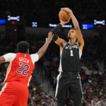 Nov 8, 2025; San Antonio, Texas, USA; San Antonio Spurs forward Victor Wembanyama (1) shoots over New Orleans Pelicans center Derik Queen (22) in the second half at Frost Bank Center. Mandatory Credit: Daniel Dunn-Imagn Images