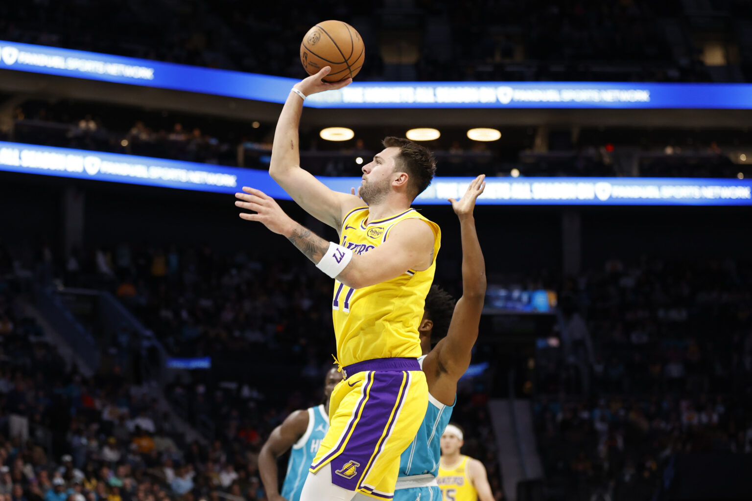 Nov 10, 2025; Charlotte, North Carolina, USA; Los Angeles Lakers forward/guard Luka Doncic (77) floats a shot towards the basket during the first quarter against the Charlotte Hornets at Spectrum Center. Mandatory Credit: Brian Westerholt-Imagn Images