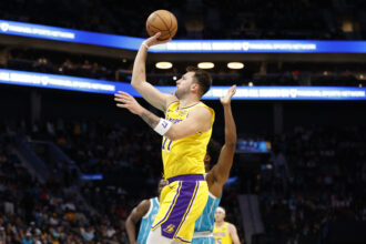 Nov 10, 2025; Charlotte, North Carolina, USA; Los Angeles Lakers forward/guard Luka Doncic (77) floats a shot towards the basket during the first quarter against the Charlotte Hornets at Spectrum Center. Mandatory Credit: Brian Westerholt-Imagn Images