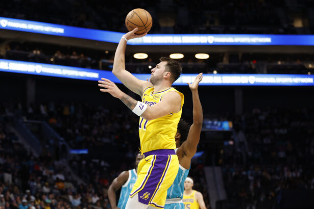 Nov 10, 2025; Charlotte, North Carolina, USA; Los Angeles Lakers forward/guard Luka Doncic (77) floats a shot towards the basket during the first quarter against the Charlotte Hornets at Spectrum Center. Mandatory Credit: Brian Westerholt-Imagn Images