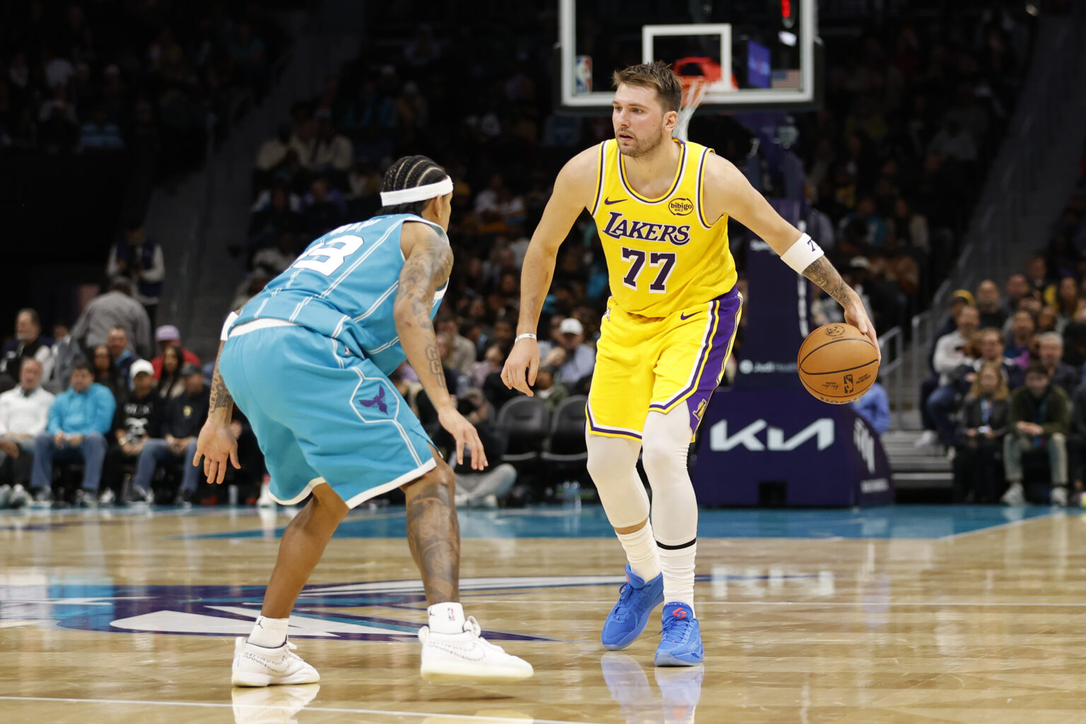 Nov 10, 2025; Charlotte, North Carolina, USA; Los Angeles Lakers forward/guard Luka Doncic (77) is guarded by Charlotte Hornets guard Tre Mann (23) during the second quarter at Spectrum Center. Mandatory Credit: Brian Westerholt-Imagn Images