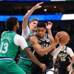 Nov 10, 2025; Dallas, Texas, USA; Milwaukee Bucks forward Giannis Antetokounmpo (34) controls the ball as Dallas Mavericks forward Cooper Flagg (32) and Dallas Mavericks forward Naji Marshall (13) defend during the first quarter at American Airlines Center. Mandatory Credit: Kevin Jairaj-Imagn Images