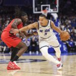 Nov 10, 2025; Orlando, Florida, USA; Orlando Magic guard Desmond Bane (3) drives the ball past Portland Trail Blazers guard Jrue Holiday (5) in the fourth quarter at Kia Center. Mandatory Credit: Nathan Ray Seebeck-Imagn Images