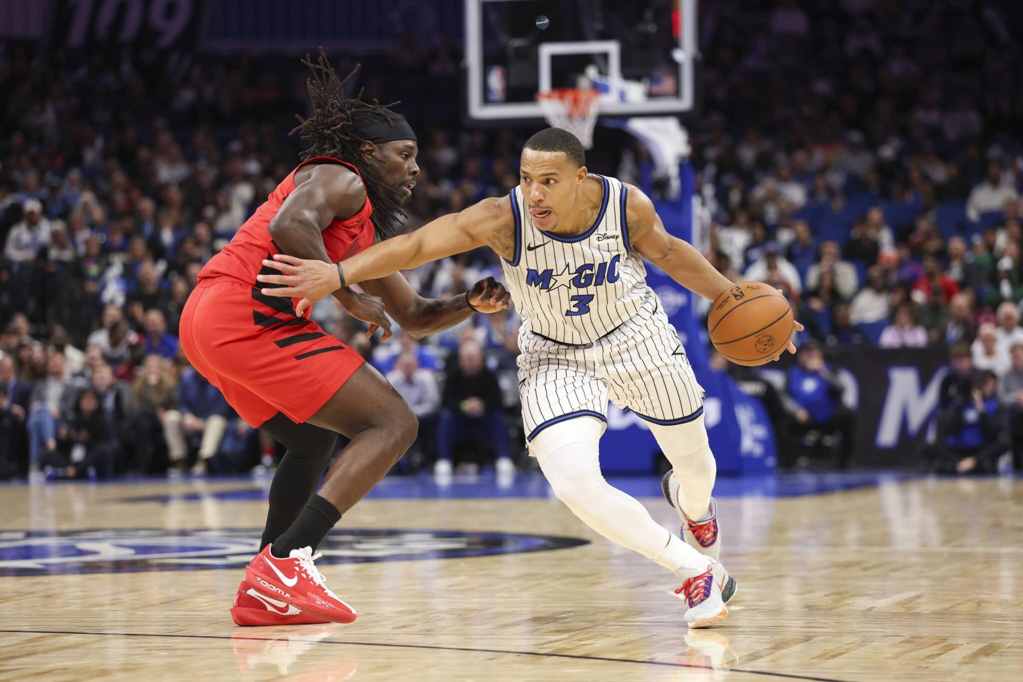 Nov 10, 2025; Orlando, Florida, USA; Orlando Magic guard Desmond Bane (3) drives the ball past Portland Trail Blazers guard Jrue Holiday (5) in the fourth quarter at Kia Center. Mandatory Credit: Nathan Ray Seebeck-Imagn Images