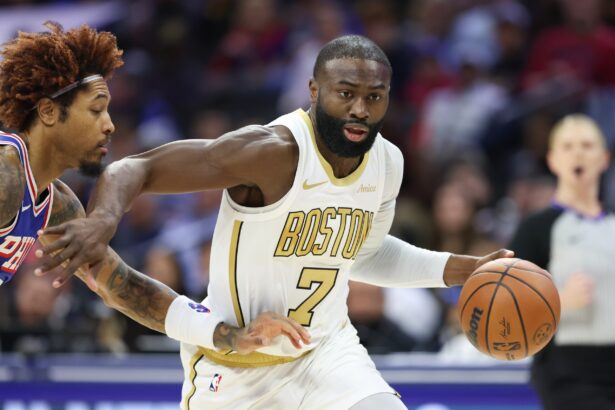 Nov 11, 2025; Philadelphia, Pennsylvania, USA; Boston Celtics guard Jaylen Brown (7) drives past Philadelphia 76ers guard Kelly Oubre Jr. (9) during the first quarter at Xfinity Mobile Arena. Mandatory Credit: Bill Streicher-Imagn Images
