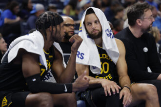 Nov 11, 2025; Oklahoma City, Oklahoma, USA; Golden State Warriors guard Buddy Hield (7) and guard Stephen Curry (30) talk on the bench during the second half against the Oklahoma City Thunder at Paycom Center. Mandatory Credit: Alonzo Adams-Imagn Images