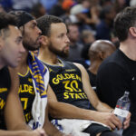 Nov 11, 2025; Oklahoma City, Oklahoma, USA; Golden State Warriors guard Stephen Curry (30) watches his team play against the Oklahoma City Thunder during the fourth quarter at Paycom Center. Mandatory Credit: Alonzo Adams-Imagn Images
