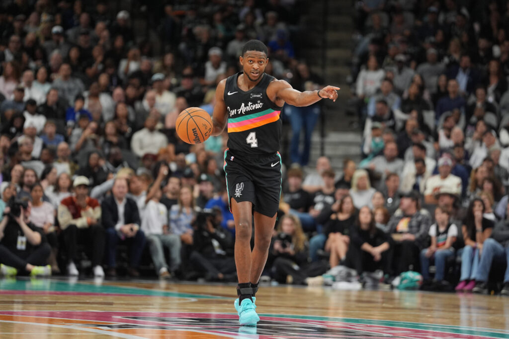 Nov 12, 2025; San Antonio, Texas, USA; San Antonio Spurs guard De'Aaron Fox (4) directs a play in the first half against the Golden State Warriors at Frost Bank Center. Mandatory Credit: Daniel Dunn-Imagn Images
