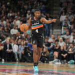Nov 12, 2025; San Antonio, Texas, USA; San Antonio Spurs guard De'Aaron Fox (4) directs a play in the first half against the Golden State Warriors at Frost Bank Center. Mandatory Credit: Daniel Dunn-Imagn Images