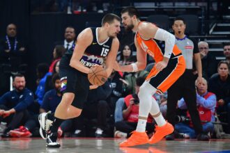Nov 12, 2025; Inglewood, California, USA; Denver Nuggets center Nikola Jokic (15) moves the ball against Los Angeles Clippers center Ivica Zubac (40) during the first half at Intuit Dome. Mandatory Credit: Gary A. Vasquez-Imagn Images