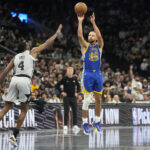 Nov 14, 2025; San Antonio, Texas, USA; Golden State Warriors guard Stephen Curry (30) shoots over San Antonio Spurs 04 guard DeAaron Fox (4) during the first half at Frost Bank Center. Mandatory Credit: Scott Wachter-Imagn Images