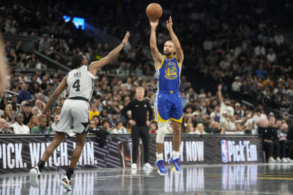Nov 14, 2025; San Antonio, Texas, USA; Golden State Warriors guard Stephen Curry (30) shoots over San Antonio Spurs 04 guard DeAaron Fox (4) during the first half at Frost Bank Center. Mandatory Credit: Scott Wachter-Imagn Images
