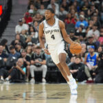 Nov 16, 2025; San Antonio, Texas, USA; San Antonio Spurs guard De'Aaron Fox (4) dribbles in the first half against the Sacramento Kings at Frost Bank Center. Mandatory Credit: Daniel Dunn-Imagn Images