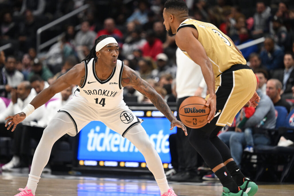 Nov 16, 2025; Washington, District of Columbia, USA; Brooklyn Nets guard Terance Mann (14) defends against Washington Wizards guard CJ McCollum (3) during the first quarter at Capital One Arena. Mandatory Credit: Rafael Suanes-Imagn Images