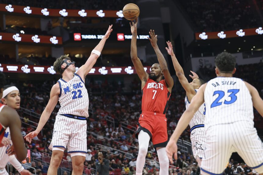 Nov 16, 2025; Houston, Texas, USA; Houston Rockets forward Kevin Durant (7) shoots the ball as Orlando Magic forward Franz Wagner (22) defends during the second quarter at Toyota Center. Mandatory Credit: Troy Taormina-Imagn Images