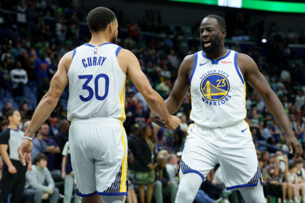 Nov 16, 2025; New Orleans, Louisiana, USA; Golden State Warriors forward Draymond Green (23) celebrates with guard Stephen Curry (30) during the first half against the New Orleans Pelicans at Smoothie King Center. Mandatory Credit: Matthew Hinton-Imagn Images