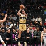 Nov 16, 2025; Washington, District of Columbia, USA; Washington Wizards forward Corey Kispert (24) attempts a jump shot in front of Brooklyn Nets forward Michael Porter Jr. (17) during the third quarter at Capital One Arena. Mandatory Credit: Rafael Suanes-Imagn Images