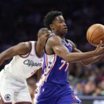 Nov 17, 2025; Philadelphia, Pennsylvania, USA; Philadelphia 76ers guard VJ Edgecombe (77) bobbles the ball in front of LA Clippers guard Kris Dunn (8) during the second quarter at Xfinity Mobile Arena. Mandatory Credit: Bill Streicher-Imagn Images
