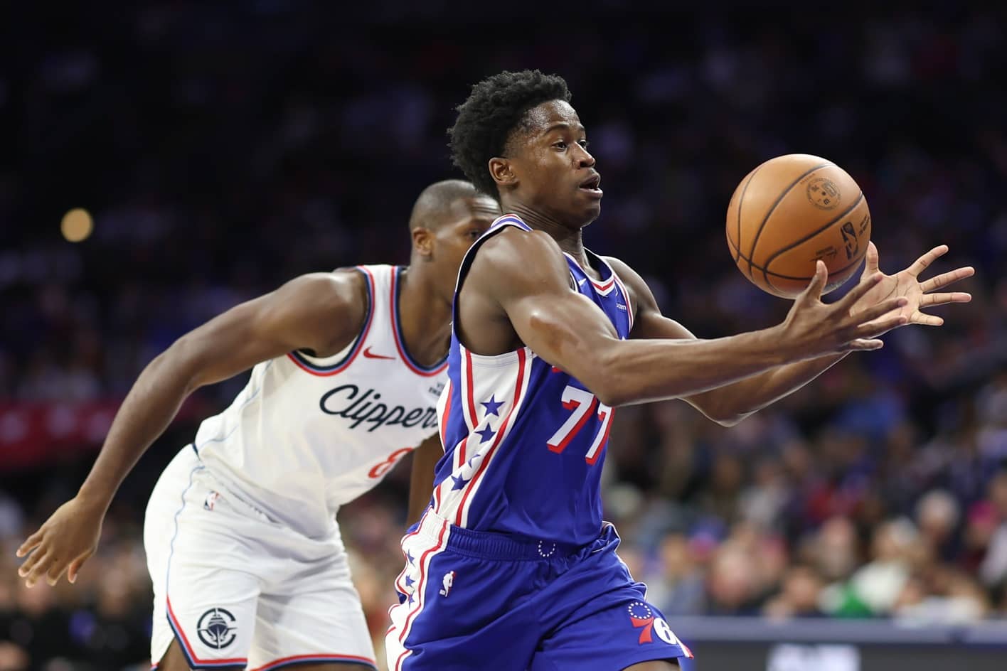 Nov 17, 2025; Philadelphia, Pennsylvania, USA; Philadelphia 76ers guard VJ Edgecombe (77) bobbles the ball in front of LA Clippers guard Kris Dunn (8) during the second quarter at Xfinity Mobile Arena. Mandatory Credit: Bill Streicher-Imagn Images